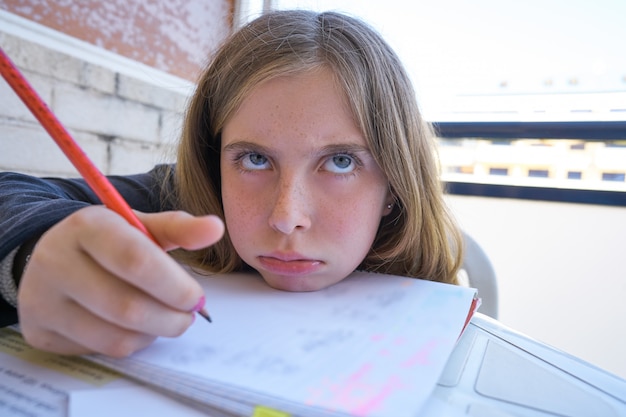 Bored student girl doing her homework