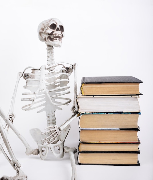 Boring education concept Skeleton and books stack Funny concept