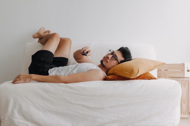 Boring life and lonely man watching tv in his living room