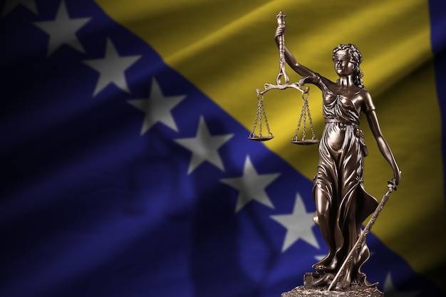 Bosnia and Herzegovina flag with statue of lady justice and judicial scales in dark room Concept of judgement and punishment