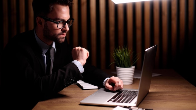 Boss of the corporation looks into his laptop