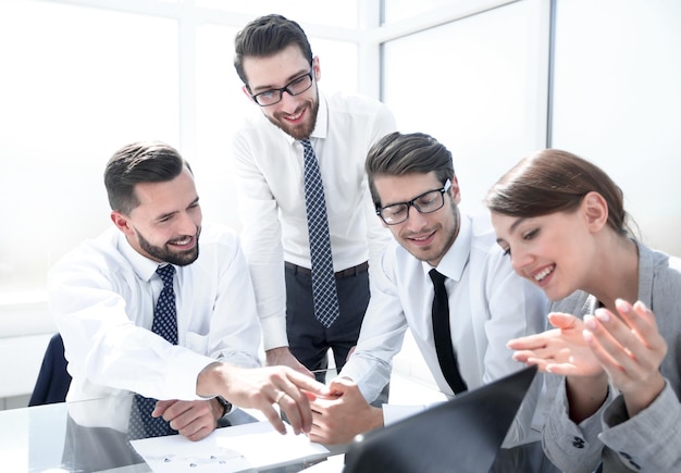 Boss pointing at the laptop screen at the meetingpeople and technology