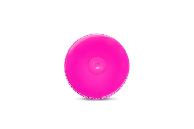 Bottle cap Top view of one pink recycled plastic cap on a white background Separate garbage