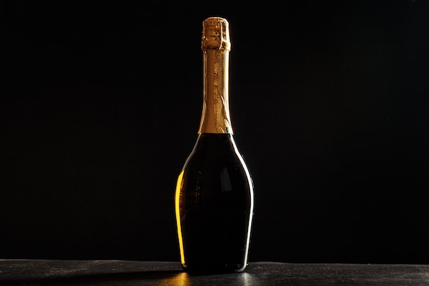 Bottle of champagne on black background.