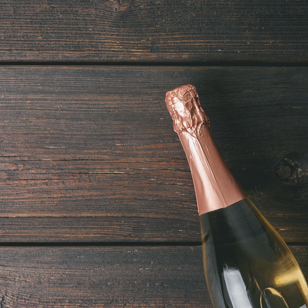 A bottle of champagne on wooden background