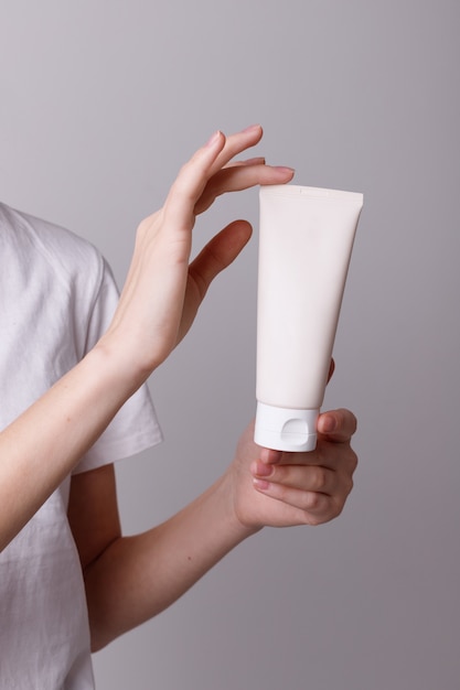 A bottle of cosmetics in the girl's hands