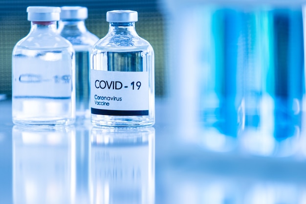 Bottle of COVOD-19 vaccine sample in a laboratory. Idea for researching and lab tests for coronavirus curing.