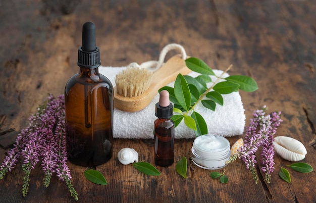 A bottle of essential oil sits on a wooden table