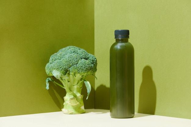 Bottle of the fresh broccoli juice on table Healthy drink