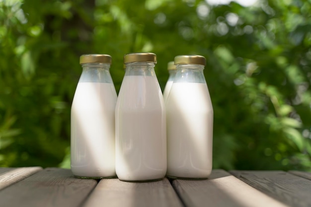 A bottle of fresh milk on a sunny summer farm meadow grass nature and plants Mockup eco food dairy