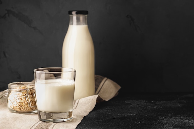 Bottle and glass of milk, front view, copy space