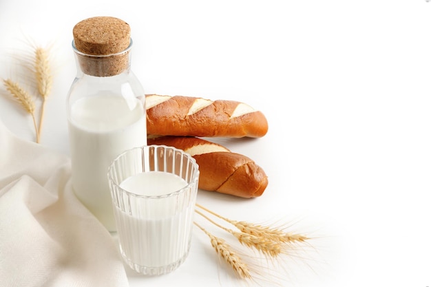 Bottle and glass with milk bread ears of wheat the concept of the Israeli holiday Shavuot