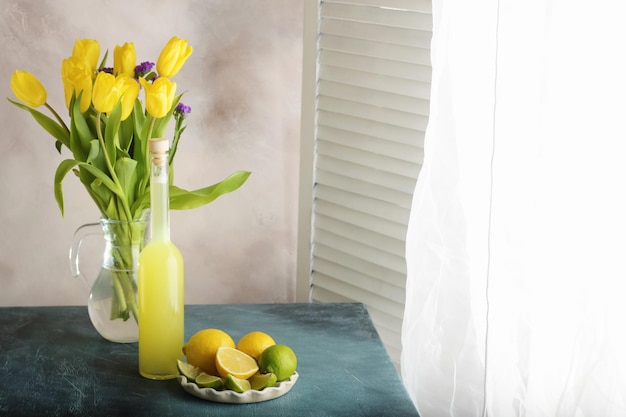 Bottle of homemade juice with ginger and lemon on light background Horizontal