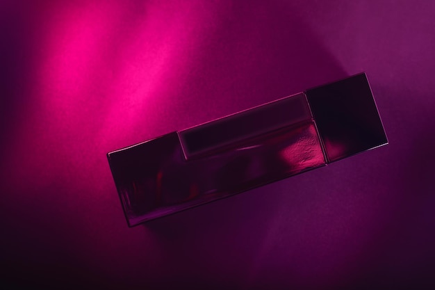 Bottle of men's perfume on a purple background