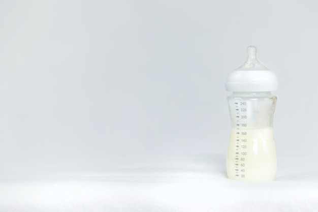 Bottle of milk baby food on a light background