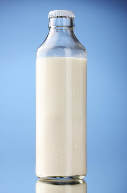 Bottle of milk on blue background