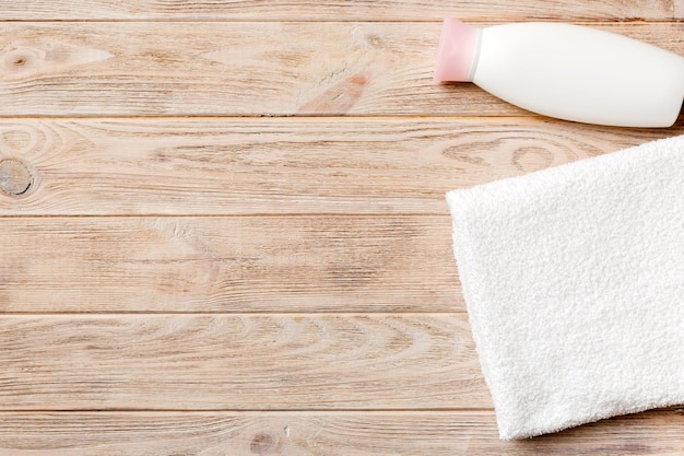 A bottle of milk, a towel and a towel on a wooden table.