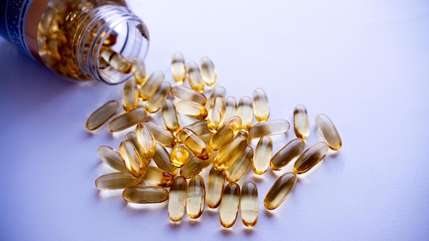 A bottle of omega 3 capsules is poured into a bottle.