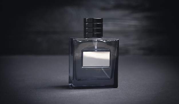 Bottle of perfume on the black background.