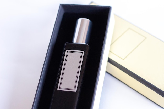 A bottle of perfume from a yellow box on a white isolated background