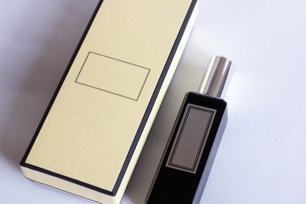 A bottle of perfume from a yellow box on a white isolated background