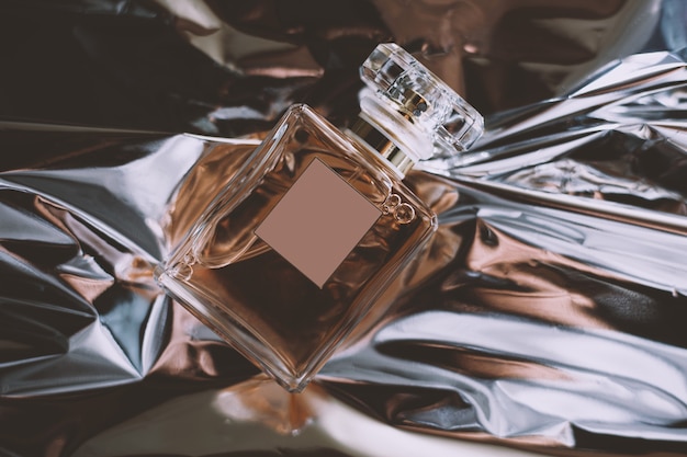 Bottle of perfume on a shiny background