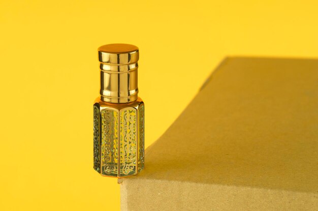 bottle and perfume on yellow background