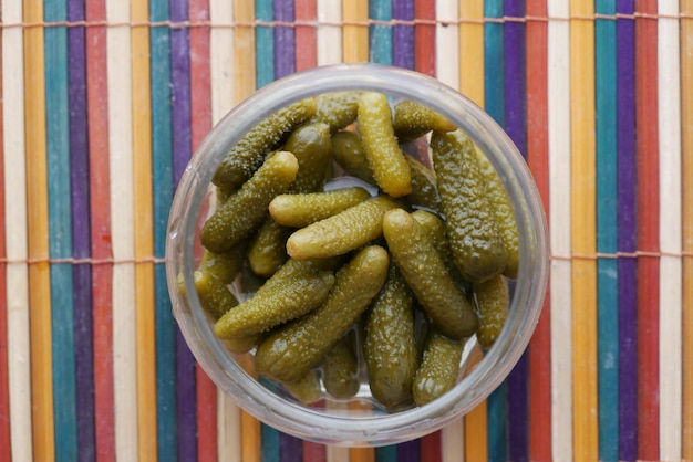 Bottle of pickled cucumbers pickles on table