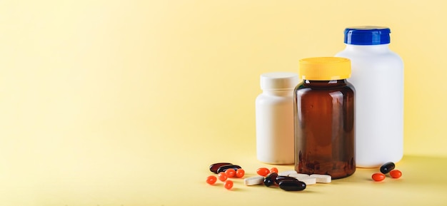 Bottle and Pills on yellow Background Medicine Healthcare Pharmacy Concept Coronavirus