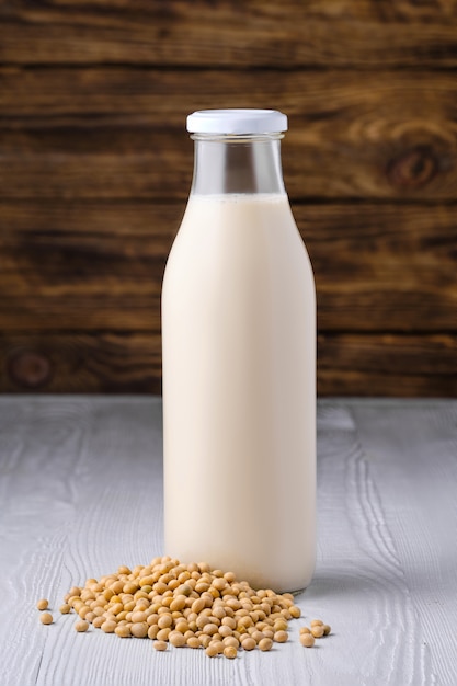 Bottle of soy milk with soybeans table