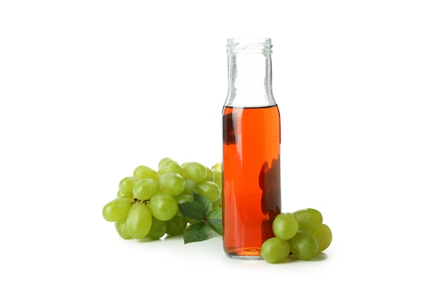 Bottle of vinegar and grape isolated on white background