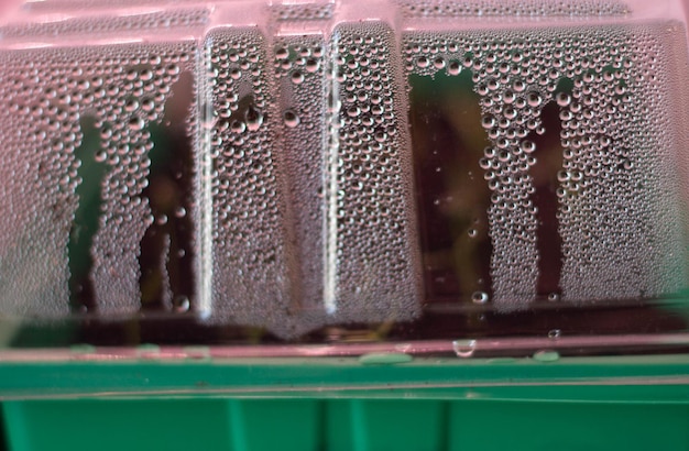 A bottle of water with condensation on the top.