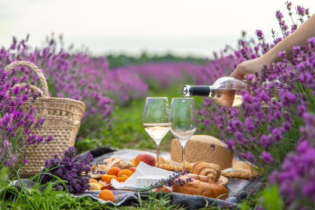 A bottle of wine on a background of a lavender field Glasses with wine fruits