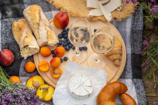 A bottle of wine on a background of a lavender field Glasses with wine fruits