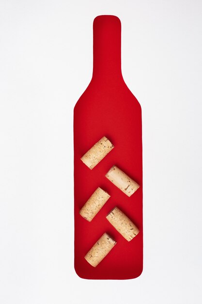 Bottle of wine is filled with wine corks. Paper figure of bottle. Concept for wine bar, restaurant