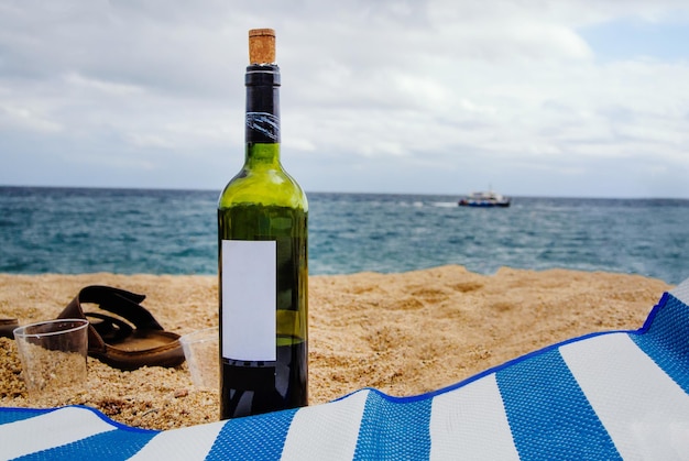 Bottle of wine in sand on the beach