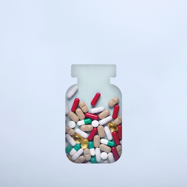 Bottle with different pills and pills. Minimalism. The concept of first aid in case of heat, temperature. Antibiotics medication.