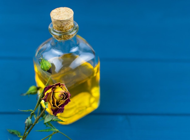 Bottle with elixir on a blue wooden background