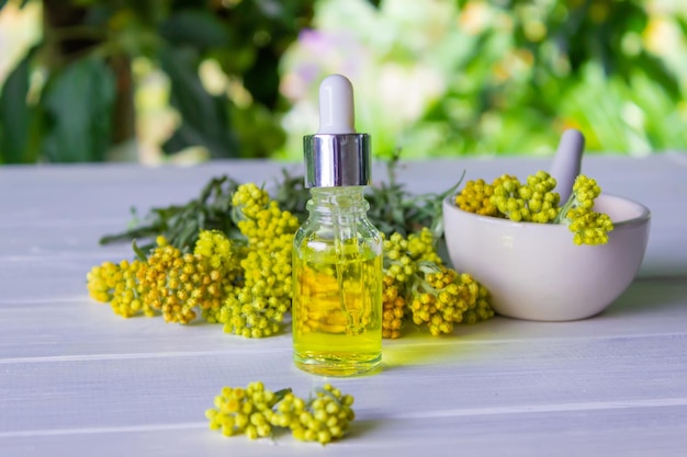 Bottle with essential oil of tansy extract tincture The concept of aromatherapy spa and herbal medicine