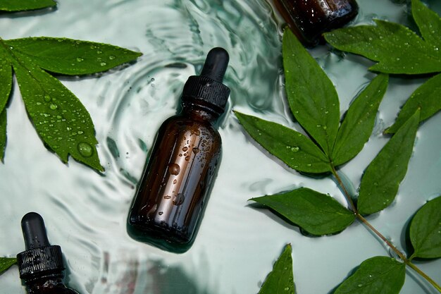 Bottle with herbal serum oil cosmetic ad simple and natural skincare concept