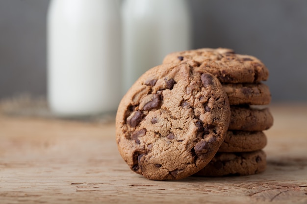 Bottle with milk and chocolate chip cookies.