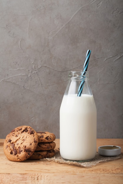 Bottle with milk and chocolate chip cookies.