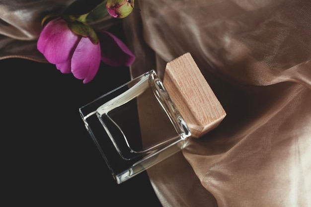 Bottle of women's perfume and flowers