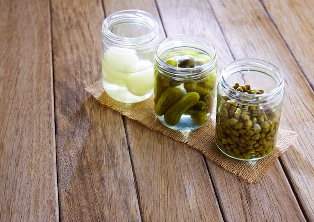 bottled pickles as capers onion and cucumbers