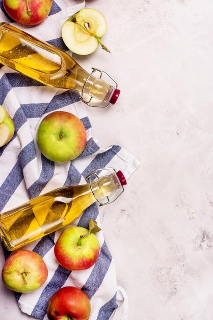 Bottles of Apple Vinegar and Ripe Apples on Light Gray Background Top View Flat Lay Apple Cider