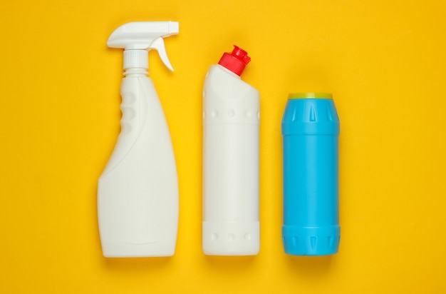 Bottles for cleaning on yellow background. Top view. Minimalism