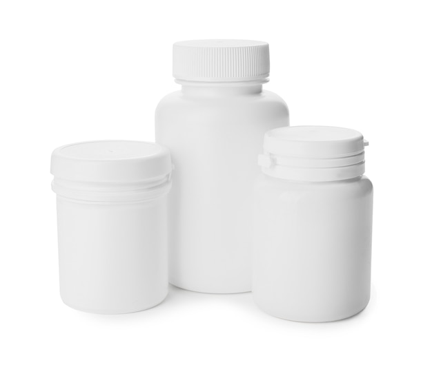 Bottles of different pills on white background