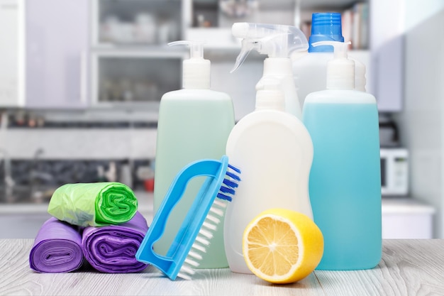 Bottles of dishwashing liquid brush and lemon