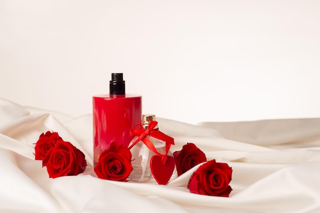 Bottles of male and female perfumeroses decorative hearts on the satin fabricGift Cosmetics