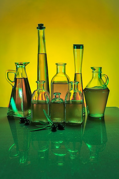 Bottles of virgin olive oil, with colored background.